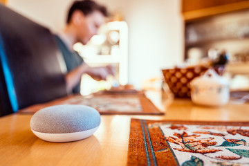 Smart ai speaker. Smart home concept with man eating in the background