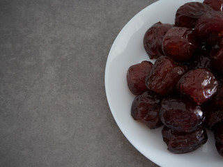 Jujube in syrup on a white plate