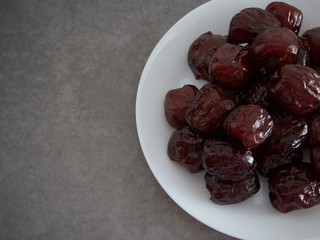 Jujube in syrup on a white plate