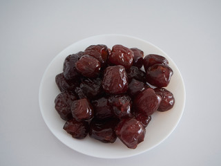 Jujube in syrup on a white plate