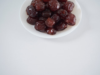 Jujube in syrup on a white plate