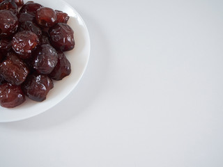 Jujube in syrup on a white plate