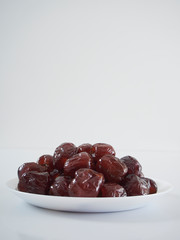 Jujube in syrup on a white plate