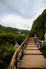 Fototapeta premium Wooden road leading to the mountains.