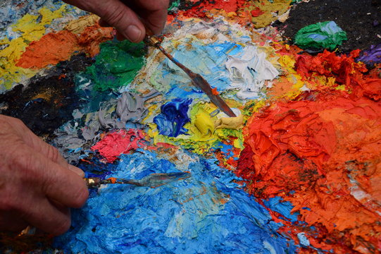 Closeup on a painter's palette in his workshop with tools