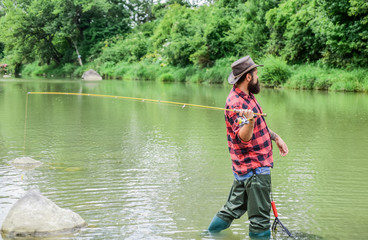 Fototapeta na wymiar Fishing outdoor sport. Fishing hobby. Teach man to fish. Fly fishing may well be considered most beautiful of all rural sports. Fisherman lucky catching fish. Good things come to those who bait