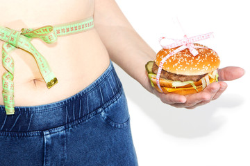 Burger cheeseburger in hands with measure tape isolated on white background. Healthy weight loss diet concept