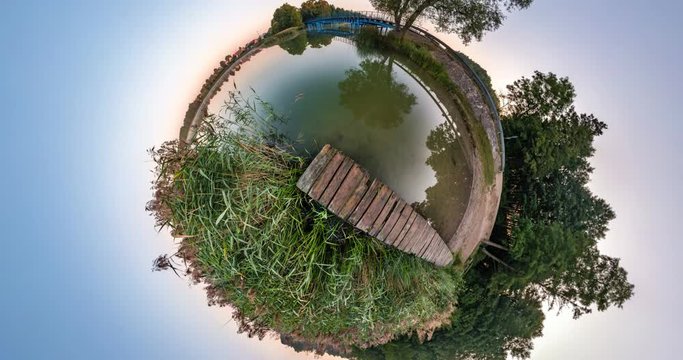 NO VR. Little planet Transformation with curvature of space. Abstract torsion and spinning of full flyby panorama of landscape in forest near lake. falling drone
