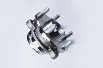 Obraz na płótnie Canvas New Wheel hub assembly with bearing. This is part of the car suspension on a gray background with a gradient. The concept of new car parts