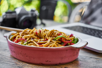 noodle and laptop on the table