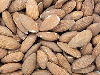 stack of almonds white background soft focus