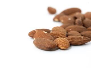 stack of almonds white background soft focus