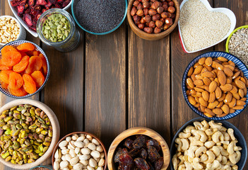nuts, seeds and dried fruis on wooden surface