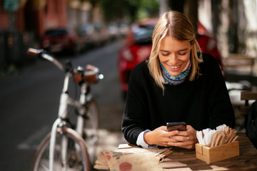 Young woman talking on phone in cafe