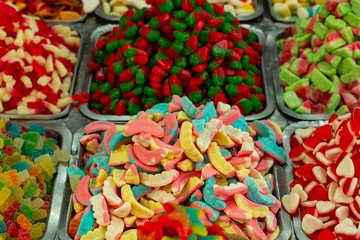 colorful sweet marmalade candies unhealthy food colorful background in market counter 