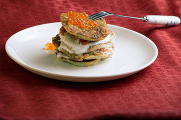 zucchini fritters and red caviar