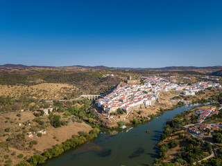 Aerial view of the town of Mértola in southeastern Portuguese Alentejo destination region, located in the margin of Guadiana River, whit its medieval castle, located on the highest point. Portugal.