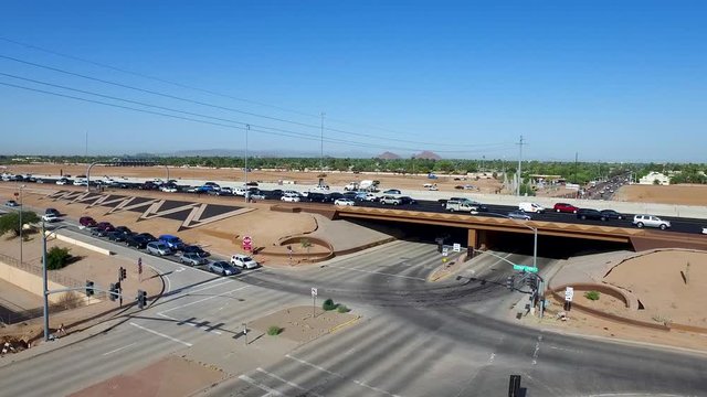 Smooth Aerial panning shot a Freeway entrance at stop light then merging and turning
