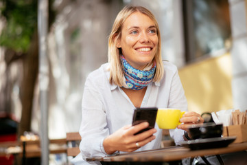 Young woman using smartphone in cafe