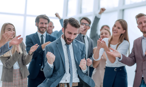 Close Up. Business Team Applauding Their Jubilant Leader