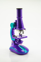 Purple microscope isolated on white.
