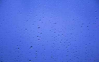 Blurry and soft water drop background on glass,on a rainy day.water drops  on the floor.