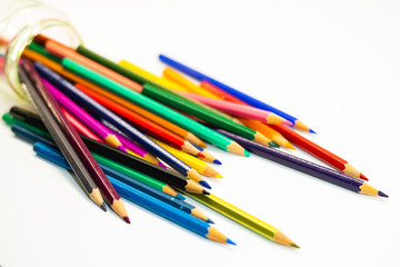 Collection of colored pencils in a jar.