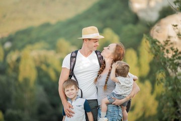 Beautiful family in the mountains. Tourism. Campaign. Fall.