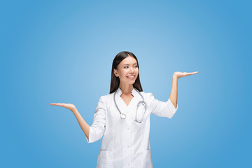 A young Asian woman doctor is scaling with her arms two different options in front of isolated and...