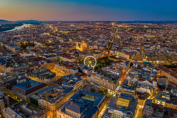 Budapest, Hungary - Aerial skyline view of city centre of Budapest with Elisabeth Square, ferris wheel and St. Stephen's Basilica with clear blue and orange sky