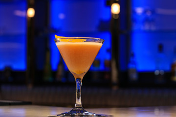 Cocktail in a tall glass on a bar.