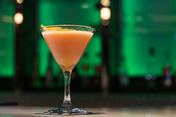 Cocktail in a tall glass on a bar.