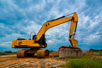 Fototapeta na wymiar Backhoe on construction site over scenic blue sky,Special heavy construction equipment for road construction.