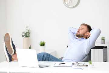 Handsome young man relaxing at workplace