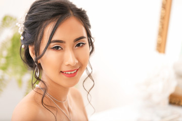 Beautiful young Asian bride at home