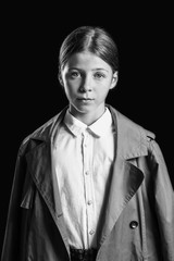 Black and white portrait of sad little girl on dark background
