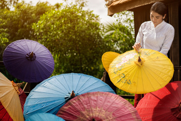 Portrait of Beautiful young Asian girls working or holding painting colorful on fabric umbrella...