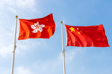 Naklejka na ściany i meble Hong Kong and Chinese Flag in Blue Sky
