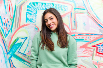 young pretty woman against graffiti wall