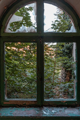 Closed old window with destroyed glass