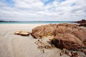 Fototapeta na wymiar Bretonic Coast and Beach with Granite Rocks at the Cote de Granit Rose - Pink Granite Coast