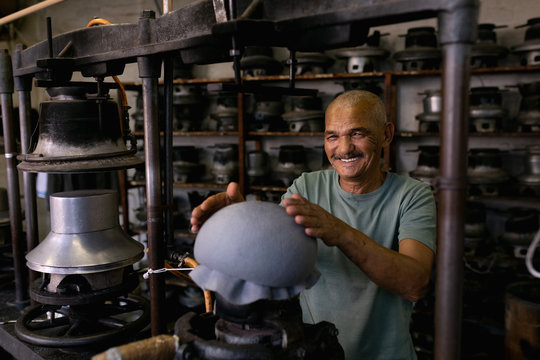 Portrait of man working in a hat factory