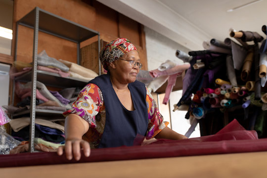 Middle aged woman working at a hat factory