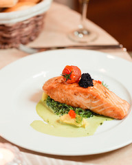 Baked salmon in a sauce with vegetables