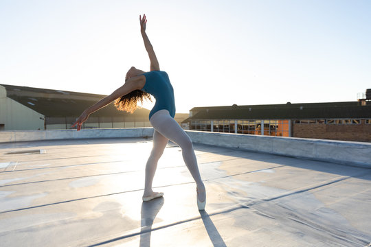 Female dancer on a rooftop - Powered by Adobe