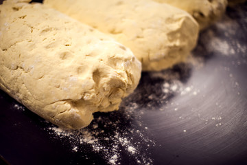 A dough with flour on the black background. Homemade food concept