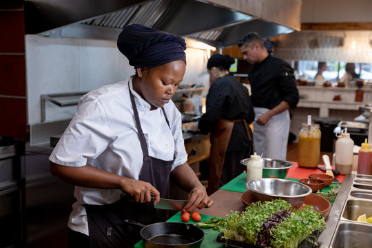 Chefs Working In Busy Restaurant Kitchen