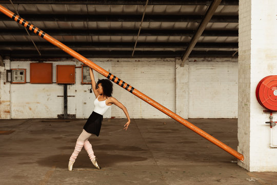 Female dancer in an empty warehouse - Powered by Adobe