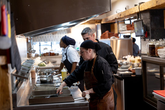 Chefs working in busy restaurant kitchen