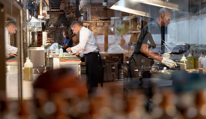 Men working in busy restaurant kitchen